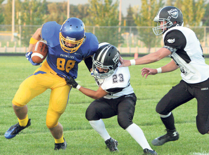 After catching a pass from quarterback Zeb Nelson,  Thief River Falls Receiver Jacob Joppru tried to fend off Dilworth-Glyndon-Felton defensive back Jordan Olson in the second quarter of Friday's high school football game at Lowell T. Swenson Field. The Rebels beat the Prowlers 37-19.
