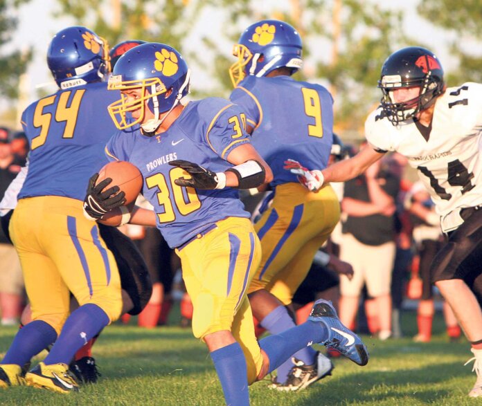 Noah Hawkins used a block by Thief River Falls teammate Ethan Halvorson (54) to get into the open for a 7-yard gain during Friday’s high school football game against Park Rapids Area. The Prowlers’ Nathanael Holecek and the Panthers’ Micah Barrett are also pictured.