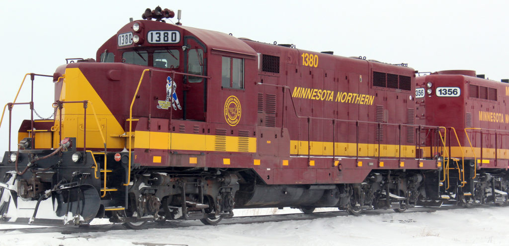 Decals on two Minnesota Northern Railroad locomotives draw attention to high school girls hockey, particularly Prowler girls hockey. On this side, the decal depicts a generic girl wearing a Prowler girls hockey jersey assigned to Lincoln High School senior Grace Bergland. Three other decals feature jerseys assigned to the other three seniors on the team.